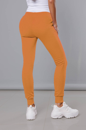 Musztardowe damskie dresowe spodnie casualowe z kieszeniami i ściągaczem